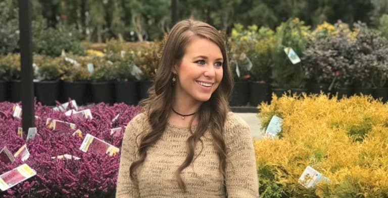 Jana Duggar smiling in front of several plants