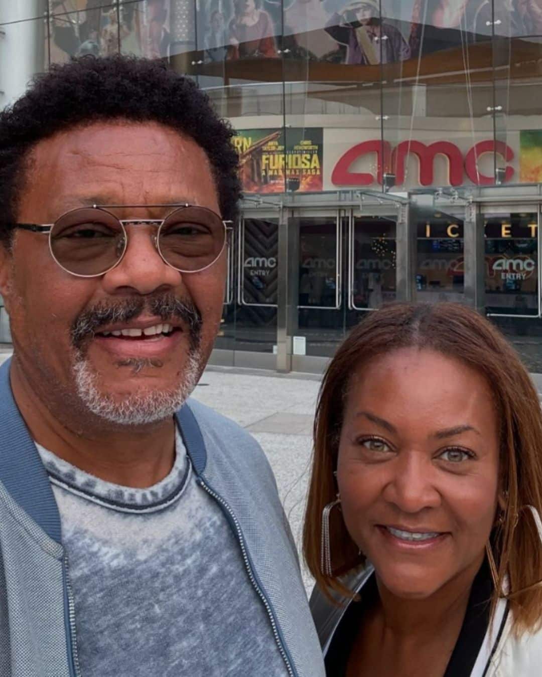 Judge Mathis and his wife Linda posing for a photo in front of a movie theater