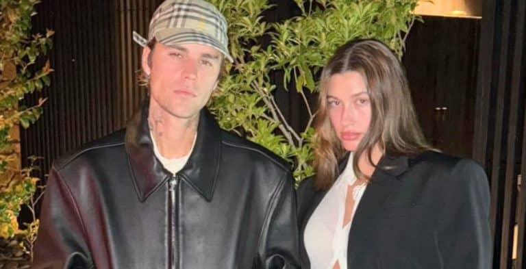 Justin and Hailey Bieber posing for a photo in black jackets