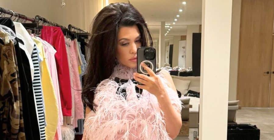 Kourtney Kardashian posing for a mirror selfie behind the scenes