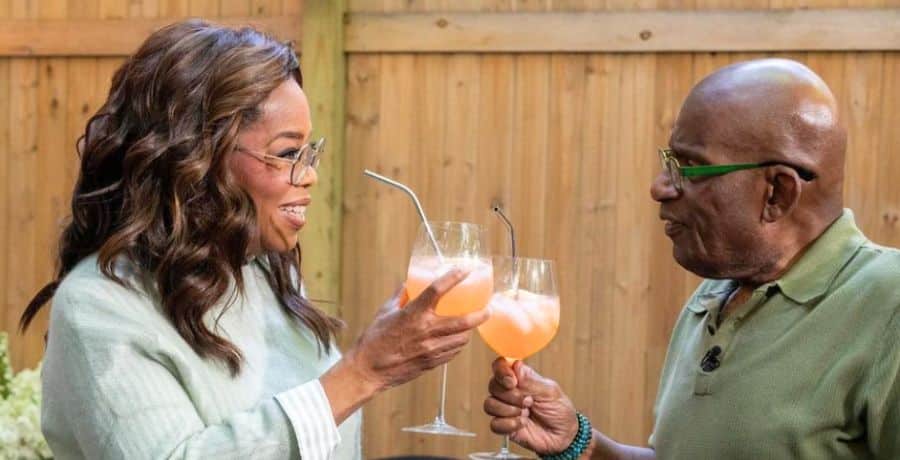 Oprah Winfrey and Al Roker clinking glasses for birthday celebration