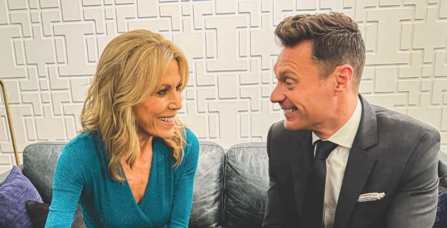 Ryan Seacrest and Vanna White looking at each other and smiling