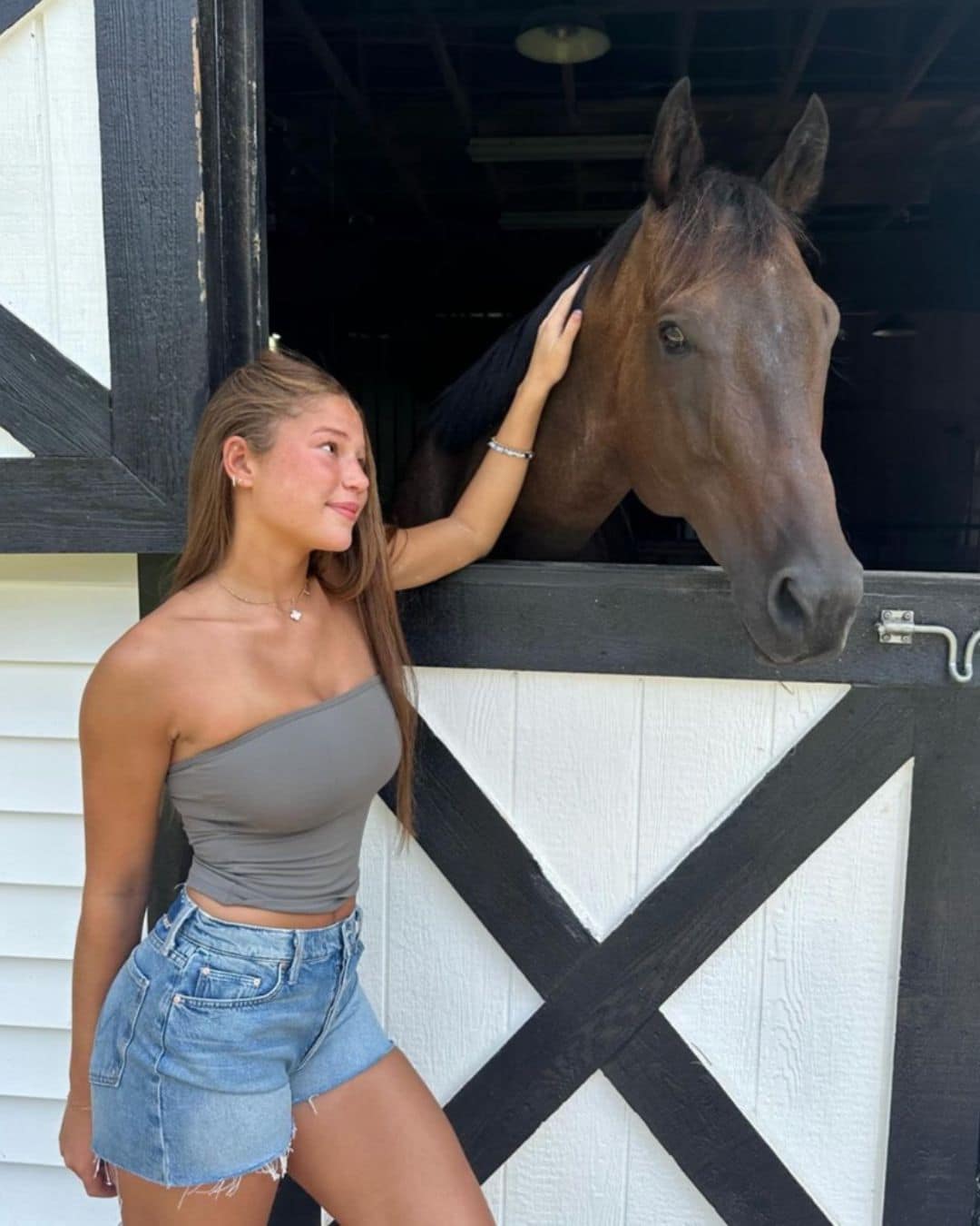 Sophia Strahan posing with a horse