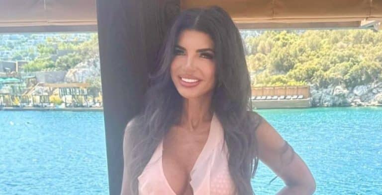 Teresa Giudice smiling and posing in front of water