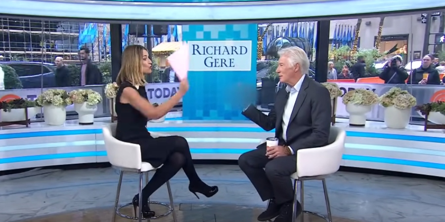 Savannah Guthrie swats Richard Gere's hand with her paper to censor his middle finger. - Today