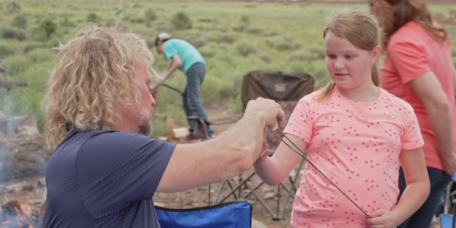 Kody Brown helps Ariella with roasting a marshmallow at Coyote Pass. - Sister Wives